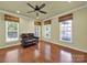 Bright living room featuring hardwood floors, natural light from large windows, and a comfortable leather sofa at 35115 Carnation Ln, Fort Mill, SC 29707