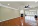 Spacious living room featuring a fireplace, hardwood floors, and an open layout connecting to a sunroom at 35115 Carnation Ln, Fort Mill, SC 29707