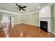 Inviting living room featuring hardwood floors, a fireplace, and an open layout with crown molding at 35115 Carnation Ln, Fort Mill, SC 29707