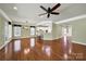 Spacious living room featuring hardwood floors, modern lighting, and an open layout connecting to the kitchen at 35115 Carnation Ln, Fort Mill, SC 29707
