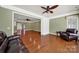 Comfortable living room featuring hardwood floors, natural light, and a view into a bright foyer at 35115 Carnation Ln, Fort Mill, SC 29707