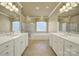 This main bathroom features double sinks, a garden tub, and a glass-enclosed shower at 35115 Carnation Ln, Fort Mill, SC 29707