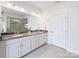 Bright bathroom featuring dual sinks, a granite countertop, white cabinets, and a large mirror with great lighting at 3807 Blazeprince Dr, Charlotte, NC 28215