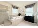 The bathroom boasts a soaking tub, a separate glass-enclosed shower, and decorative window treatments at 3807 Blazeprince Dr, Charlotte, NC 28215