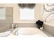A luxurious soaking tub and glass shower enclosure are complemented by elegant decor and window treatment at 3807 Blazeprince Dr, Charlotte, NC 28215