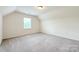Neutral bedroom features a large window, providing ample natural light, with soft carpet flooring at 3807 Blazeprince Dr, Charlotte, NC 28215