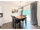 The dining area features a modern light fixture, a table with chairs, and a sliding glass door for outdoor access at 3807 Blazeprince Dr, Charlotte, NC 28215