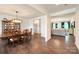 Elegant dining room with hardwood floors, a large wooden table, and a hutch for displaying dinnerware at 3807 Blazeprince Dr, Charlotte, NC 28215