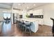 A modern, open kitchen features a large island with barstool seating, stainless appliances, and granite countertops at 3807 Blazeprince Dr, Charlotte, NC 28215