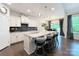 Modern kitchen with white cabinets, a granite island with seating, and stainless steel appliances at 3807 Blazeprince Dr, Charlotte, NC 28215