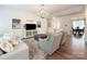 Open-concept living room with neutral decor, a plush rug, and views into the dining room at 3807 Blazeprince Dr, Charlotte, NC 28215