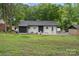 Lush backyard featuring a well-manicured lawn and a charming exterior at 3900 Colebrook Rd, Charlotte, NC 28215
