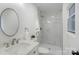 Modern bathroom featuring a sleek vanity, a stylish round mirror, and a luxurious walk-in shower at 3900 Colebrook Rd, Charlotte, NC 28215