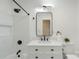 Renovated bathroom featuring black fixtures, white subway tile and vanity with sink at 3900 Colebrook Rd, Charlotte, NC 28215