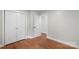 This bedroom features warm wood floors, white trim and closet at 3900 Colebrook Rd, Charlotte, NC 28215