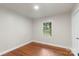 Cozy bedroom showcasing a window view of the neighborhood and warm wood floors at 3900 Colebrook Rd, Charlotte, NC 28215