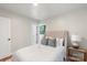 Serene bedroom features a plush queen bed, neutral decor, and soft lighting, perfect for relaxation at 3900 Colebrook Rd, Charlotte, NC 28215