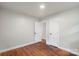 Bright bedroom features neutral walls, warm wood floors, and white trim at 3900 Colebrook Rd, Charlotte, NC 28215