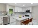 Modern kitchen featuring white cabinets, stainless steel appliances, and a large island at 3900 Colebrook Rd, Charlotte, NC 28215