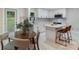 Charming kitchen featuring white cabinets, quartz countertops, and a cozy dining nook, perfect for casual meals at 3900 Colebrook Rd, Charlotte, NC 28215