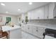 Contemporary kitchen with white cabinets, stainless steel appliances, and a spacious island at 3900 Colebrook Rd, Charlotte, NC 28215