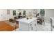 Open concept kitchen boasts a large white island, marble floors, and access to a cozy living room at 3900 Colebrook Rd, Charlotte, NC 28215