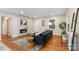 Cozy living room with hardwood floors, a modern fireplace, and ample natural light at 3900 Colebrook Rd, Charlotte, NC 28215