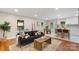 Open-concept living room with hardwood floors, comfortable seating, and lots of natural light at 3900 Colebrook Rd, Charlotte, NC 28215
