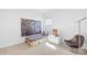 Minimalist bedroom design with a platform bed, modern chair, and artwork enhancing the room's contemporary feel at 3938 Isenhour Rd, Kannapolis, NC 28081