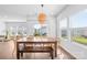 Bright dining room with large table and bench seating, with view of the green backyard at 3938 Isenhour Rd, Kannapolis, NC 28081