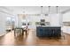 Bright kitchen features an island with seating, stainless appliances, and a dining area with access to a patio at 3938 Isenhour Rd, Kannapolis, NC 28081