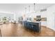 Open-concept kitchen featuring a large island with seating, stainless appliances, and hardwood floors at 3938 Isenhour Rd, Kannapolis, NC 28081