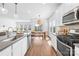 Open kitchen with stainless steel appliances, subway tile backsplash, and a large island with a sink at 3938 Isenhour Rd, Kannapolis, NC 28081