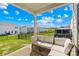 Inviting patio area with comfortable seating, overlooking a well-maintained backyard and neighborhood landscape at 3938 Isenhour Rd, Kannapolis, NC 28081
