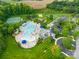 Aerial view of community pool, tennis courts, basketball courts, a playground, and clubhouse with meticulously maintained grounds at 3938 Isenhour Rd, Kannapolis, NC 28081