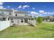 Well-maintained backyard with healthy lawn, a white fence, and the home's siding at 4003 Rothwood Ln, Harrisburg, NC 28075