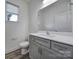 Bathroom featuring modern vanity with gray cabinets, a marble countertop, and a bright vanity mirror at 4003 Rothwood Ln, Harrisburg, NC 28075