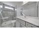 Modern bathroom featuring sleek gray tile, glass shower, and a stylish vanity with ample counter space at 4003 Rothwood Ln, Harrisburg, NC 28075