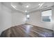 Bright bedroom features hardwood floors, recessed lighting, tray ceiling and two windows for ample natural light at 4003 Rothwood Ln, Harrisburg, NC 28075