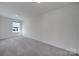 Bright bedroom space offering a minimalist design and ample room for personalization at 4003 Rothwood Ln, Harrisburg, NC 28075