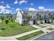 Lovely townhomes with lush green lawn and mature trees, creating a welcoming and picturesque neighborhood setting at 4003 Rothwood Ln, Harrisburg, NC 28075