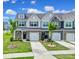 Charming townhome featuring a well-manicured lawn and attached garages, offering a blend of comfort and curb appeal at 4003 Rothwood Ln, Harrisburg, NC 28075