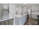 Well-equipped kitchen featuring an island, stainless steel appliances, and convenient storage, designed for functionality at 4003 Rothwood Ln, Harrisburg, NC 28075