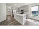 Bright kitchen with an island, stainless steel appliances, and ample counter space, ideal for culinary enthusiasts at 4003 Rothwood Ln, Harrisburg, NC 28075