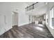 Open-concept living room with a kitchen view, high ceilings, and modern flooring, perfect for entertaining at 4003 Rothwood Ln, Harrisburg, NC 28075