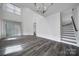 Spacious living room with high ceilings, natural light, and modern flooring, creating an inviting atmosphere at 4003 Rothwood Ln, Harrisburg, NC 28075