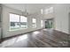 Bright living room with large windows, stylish flooring, and modern lighting, offering comfort and elegance at 4003 Rothwood Ln, Harrisburg, NC 28075