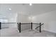 Spacious loft area features dark railing and trim, neutral carpet and lots of natural light at 4003 Rothwood Ln, Harrisburg, NC 28075