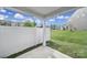 The patio has a view of the surrounding neighborhood, white fencing, and a green lawn at 4003 Rothwood Ln, Harrisburg, NC 28075