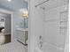 Bright bathroom featuring subway tiles, a tub with shower, and modern fixtures at 413 E Worthington Ave, Charlotte, NC 28203